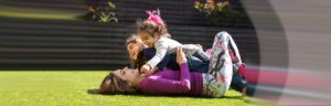 Kathy and Her Daughters Playing in the Grass