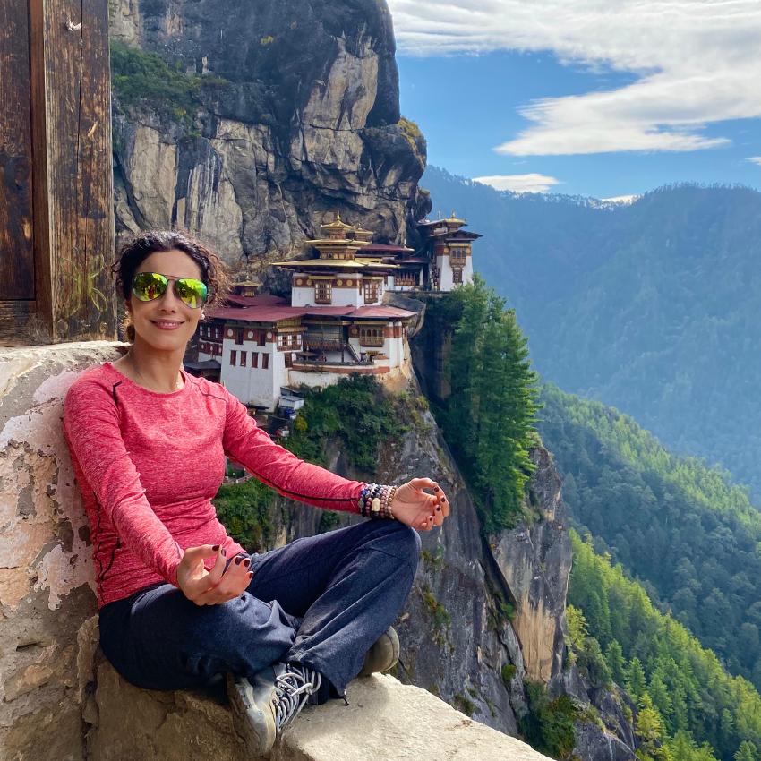 Kati Jalali in Bhutan near the Tiger's Nest Monastery focusing on self-discovery.