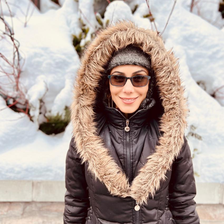 Kati Jalali standing in a snow-covered landscape focusing on burnout prevention